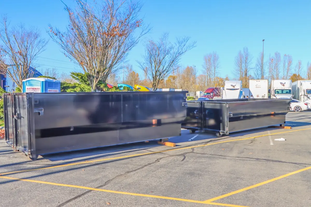Professional dumpster rental service with roll-off container on residential driveway in The Hammocks
